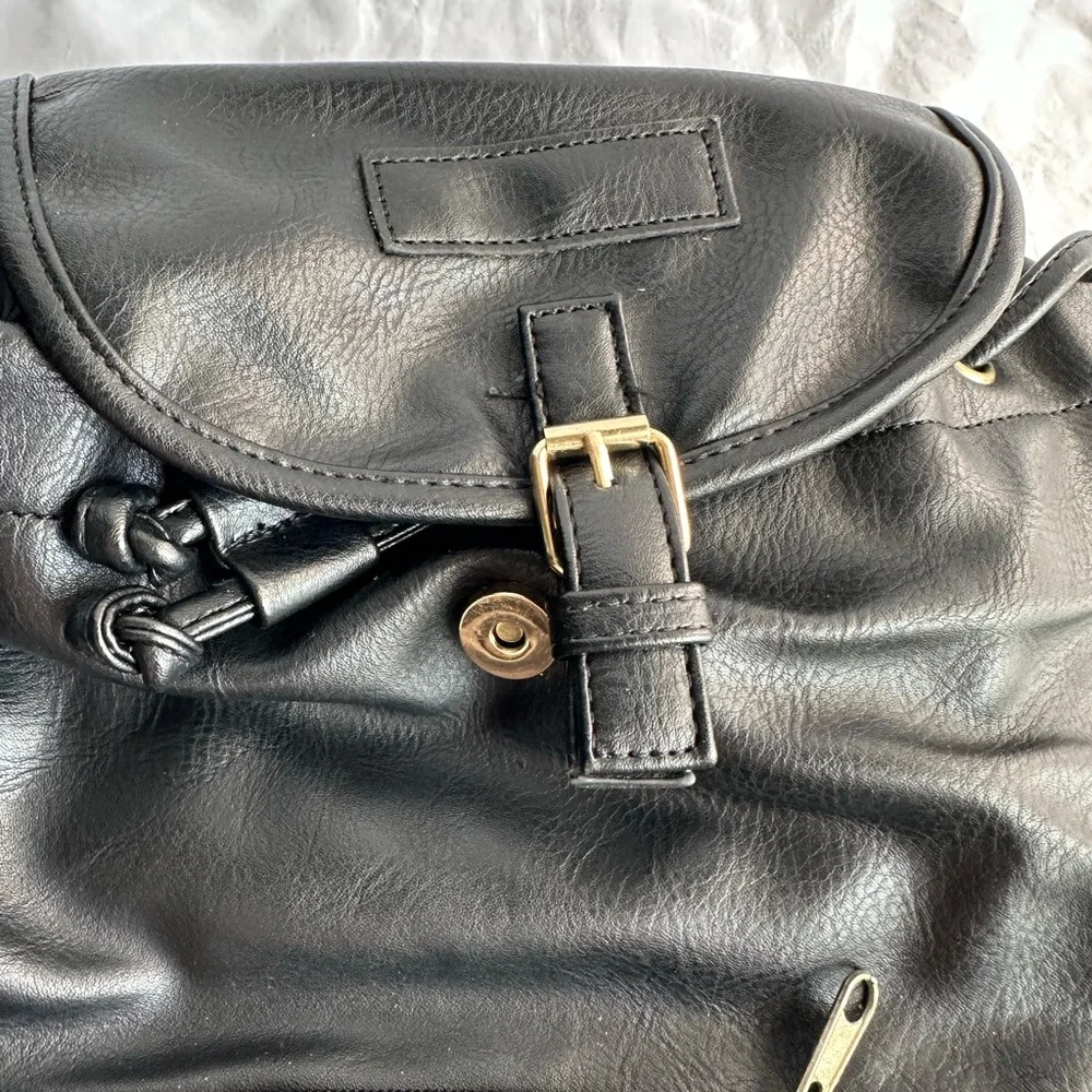 Black Faux Leather Drawstring Backpack with Gold Buckle Accent